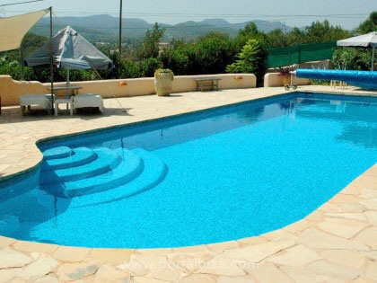 The swimming pool is surrounded by terraces